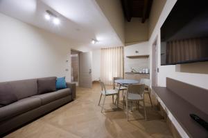 a living room with a couch and a table and chairs at B&B Alba in Celano