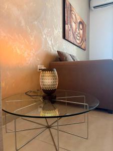a glass table with a vase on top of it at The Bright Bridge, Near Sliema with AC in Il-Gżira