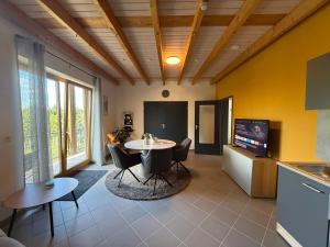 a kitchen with a table and chairs in a room at Landhaus Kummerfrei in Hellenthal