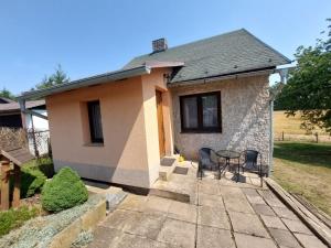 a small house with a table and chairs outside at Chata Rumunka in Jaroměř +4 photos