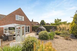 a garden with a patio and a house at 5 Bed in Bodham oc-2204 in Bodham