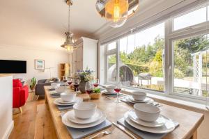 a dining room with a table with dishes on it at 5 Bed in Bodham oc-2204 in Bodham