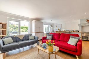 a living room with a red couch and a table at 5 Bed in Bodham oc-2204 in Bodham