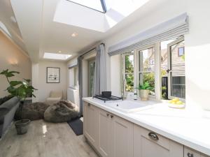 a kitchen with a sink and a large window at 12 Manor Farm Close in Kingham