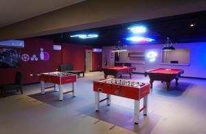 three ping pong tables in a room with billards at Blue Coast Condo in Puerto Plata