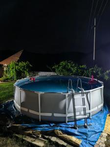 a bath tub sitting on a tarp next to a pool at Etno Kuća Jaćimović 1 in Pranjani