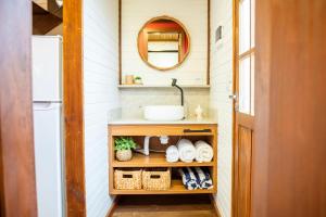 a small bathroom with a sink and a mirror at Morada dos Butiás in Imbituba +36 photos