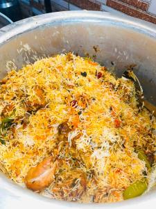 a pot filled with rice and chicken and vegetables at Ibrahim lodge restaurant in Astor +4 photos