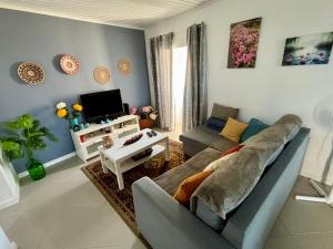a living room with a couch and a tv at Casa das Courelas in Nordeste