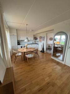 a dining room and kitchen with a table and chairs at Modern apartment with large balcony in Halmstad