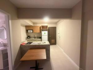 a small kitchen with a counter and a refrigerator at View Soft House - Quarto e Sala 213 in Lauro de Freitas