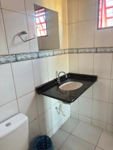 a bathroom with a sink and a toilet at Pousada Marialva in Barreiras