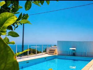 a swimming pool with a view of the ocean at La Locanda Del Carrubo in Mattinata