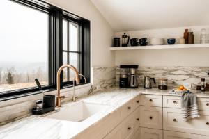 a kitchen with a sink and a window at Onyx Ridge Breathtaking Views 14 Acres in Jeffersonville +32 photos