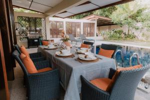 a table and chairs with a table and a pool at The Villa - Private Pool near Tanjung Rhu Beach by WOW Holiday Homes in Kuah +58 photos