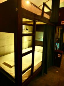 a bunk bed with white beds in a room at Way of The Bay in Arugam Bay