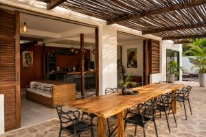 an outdoor dining room with a wooden table and chairs at Casa La Rayanna in Palomino