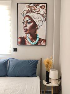 a black woman with a headdress on a wall at Mountain Aura - Stylish Escape in Kamarítsa