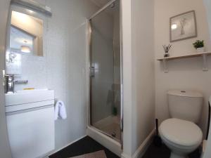 a bathroom with a toilet and a glass shower at Central Stay Blackpool in Blackpool +10 photos