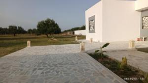 a house with a stone walkway in front of a building at Chalet Dar Well-Ness in Dar Mohammed Salah +5 photos
