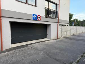 two garage doors on the side of a building at MOOD Apartment Piešťany Centrum, parking, terasa in Piešťany