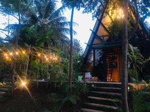a house with lights and stairs in front of it at LIVAA NEST Resort Mysore in Kālvādi