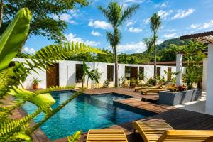 a swimming pool with chairs and a house at Casa La Rayanna in Palomino +25 photos