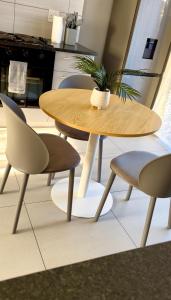 a table and two chairs and a table with a plant on it at Nova Apartments- MbabaneCBD in Mbabane +15 photos