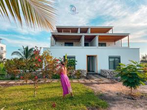 a woman standing in front of a house at Zanzibar Stays Accommodation Collection, The Soul, Paje in Paje +74 photos
