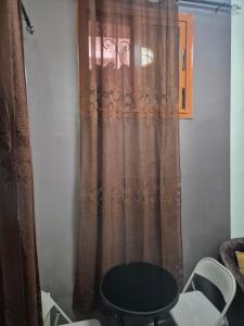a table and chairs in front of a curtain at SEN-HOME Free in Dakar +27 photos