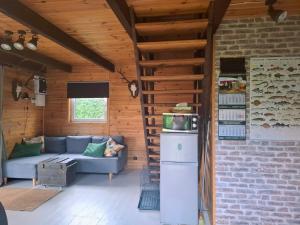 a living room with a couch and a refrigerator at Śledziowy Domek  +29 photos