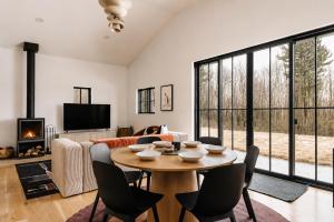 a living room with a table and chairs at Onyx Ridge Breathtaking Views 14 Acres in Jeffersonville