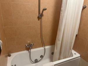 a shower in a bathroom with a shower curtain at Team Diablo Accommodations in Molinella