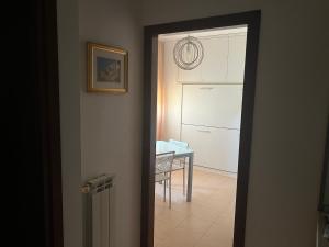 a door leading to a kitchen with a table in a room at Team Diablo Accommodations in Molinella