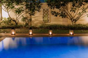 a group of candles sitting next to a swimming pool at The Villa - Private Pool near Tanjung Rhu Beach by WOW Holiday Homes in Kuah