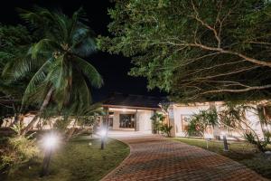 a driveway leading to a house at night at The Villa - Private Pool near Tanjung Rhu Beach by WOW Holiday Homes in Kuah