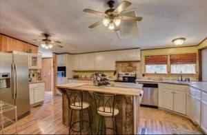 a kitchen with white cabinets and a ceiling fan at The Moseley-Smith Plantation SHARED LIVING Queen Bedroom in Aiken