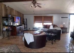 a living room with a couch and a tv at The Moseley-Smith Plantation SHARED LIVING Queen Bedroom in Aiken