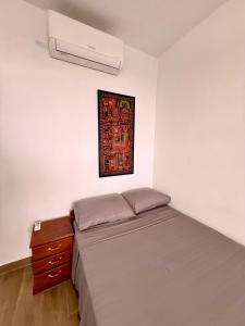 a bedroom with a bed and a picture on the wall at Chaikoni Lodge in Pucallpa