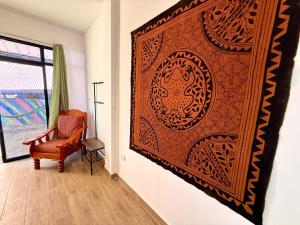 a large wall art in a room with a chair at Chaikoni Lodge in Pucallpa