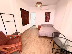 a bedroom with a bed and a table and chairs at Chaikoni Lodge in Pucallpa