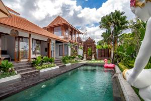 a pool in a villa with a pool slide at Dream Nest Bali in Munggu