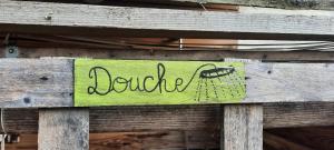 a sign on a wooden fence with the word louille at Une roulotte dans les vignes Ancenis in Vallons-de-l'Erdre