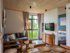 a living room with a couch and a bed at Zanzibar Stays Accommodation Collection, The Soul, Paje in Paje