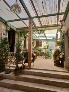 a patio with a wooden pergola with a table at Chambres d'Hôtes de La Vallée Du Serein in Annay-sur-Serein