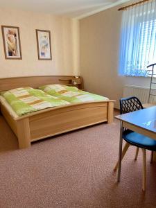 a bedroom with a large bed and a table at B&B Pension-Schönheim in Monzingen +41 photos