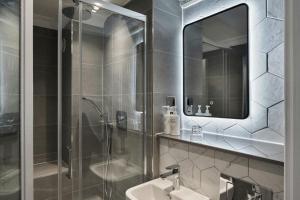 a bathroom with a shower and a sink and a mirror at Four Points Flex by Sheraton Nottingham in Nottingham