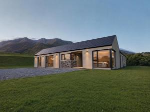 a house on a hill with mountains in the background at Sea Mourne View in Carlingford