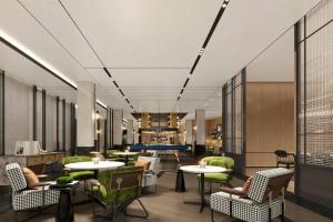a lobby with tables and chairs and a pool table at Four Points by Sheraton Guilin Central in Guilin