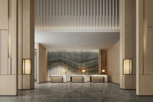 a lobby with tables and a painting on the wall at Courtyard by Marriott Rizhao in Rizhao +8 photos